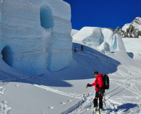 A man skiing overlooking the snow cave