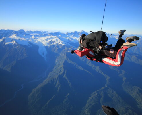 Tandem skydiving overlooking the mountains in Franz Josef.