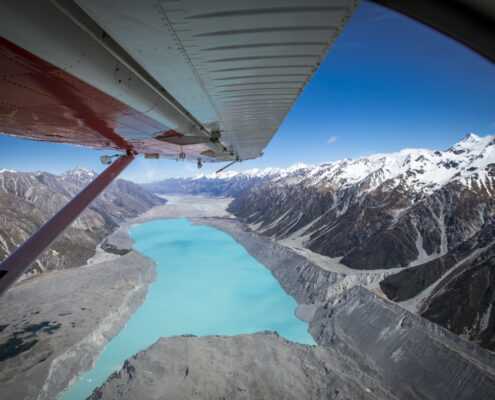 A wing of a heli overlooking the lake and Mount Cook