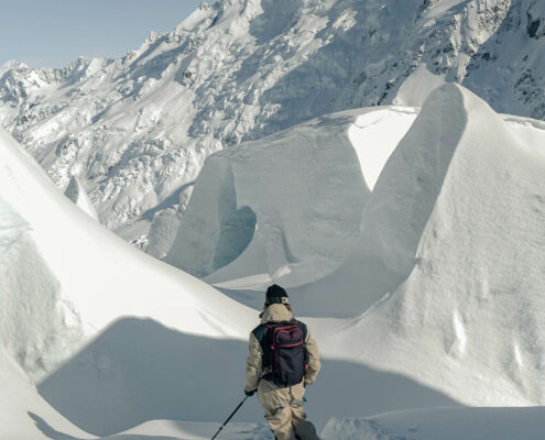 A man ski boarding on the Tasman from the ground to the peak.