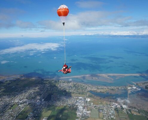 Skydiving from a far above Abel Tasman