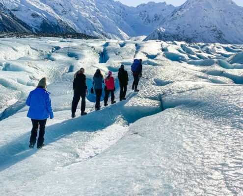 A group snowshoeing in Mount Cook from the base closed-up