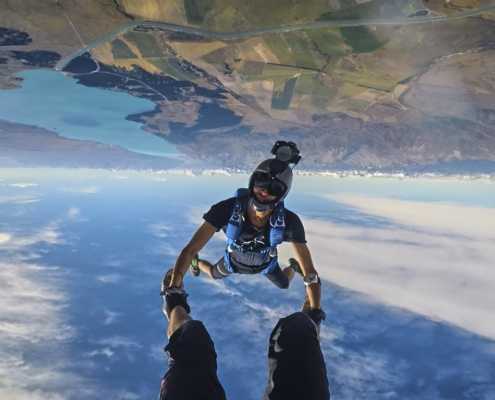 A man sports skydiving photographed upside-down.